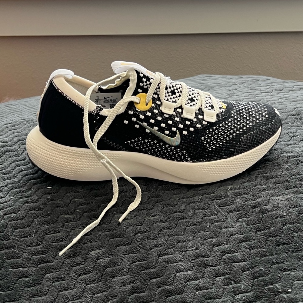 Nike Women’s Black/White/Gold Accents Fly Knit Sneakers